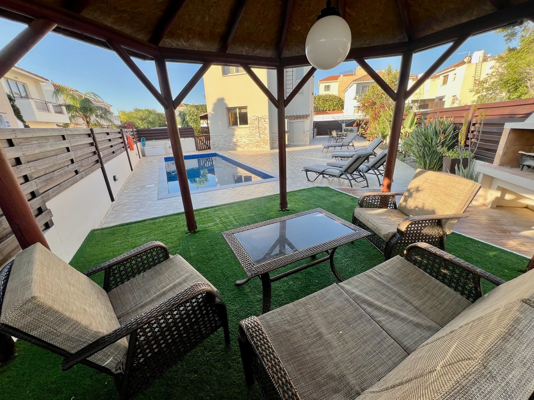 Shaded outdoor seating area beside the pool